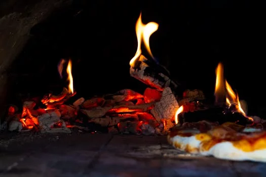 wood fired pizza oven flames cooking